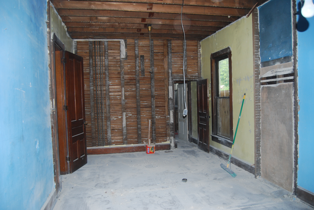 View of bathroom space, stair case area, and part of the playroom after closets were removed