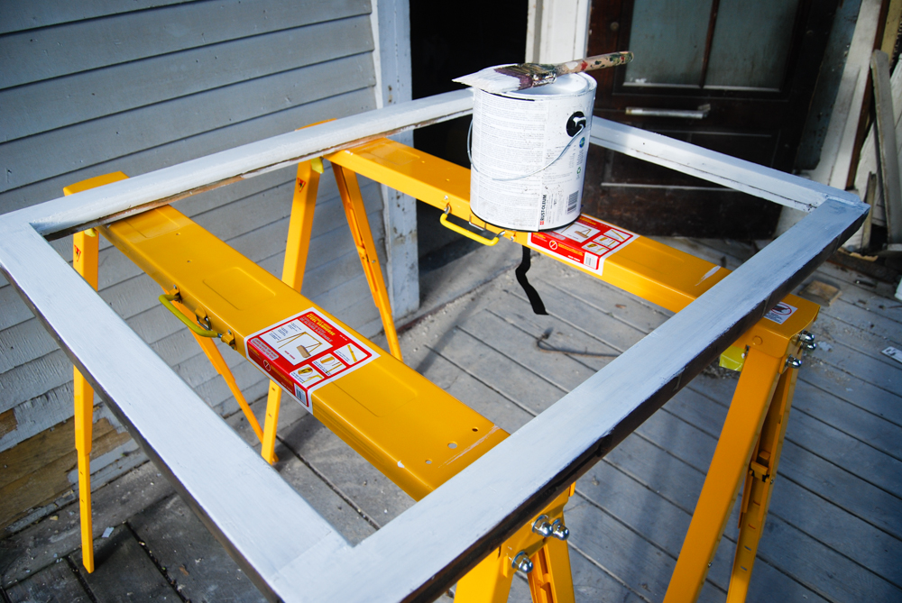 Priming the sash after it has been scraped and sanded