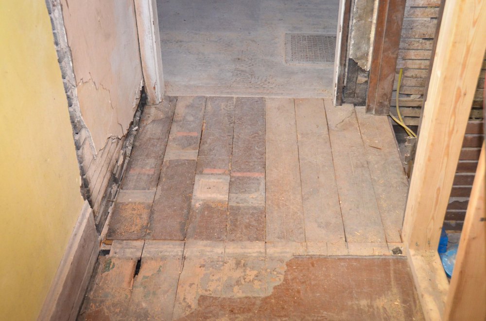 New landing at the top of the basement stairs, including new floorboards ripped from bathroom
